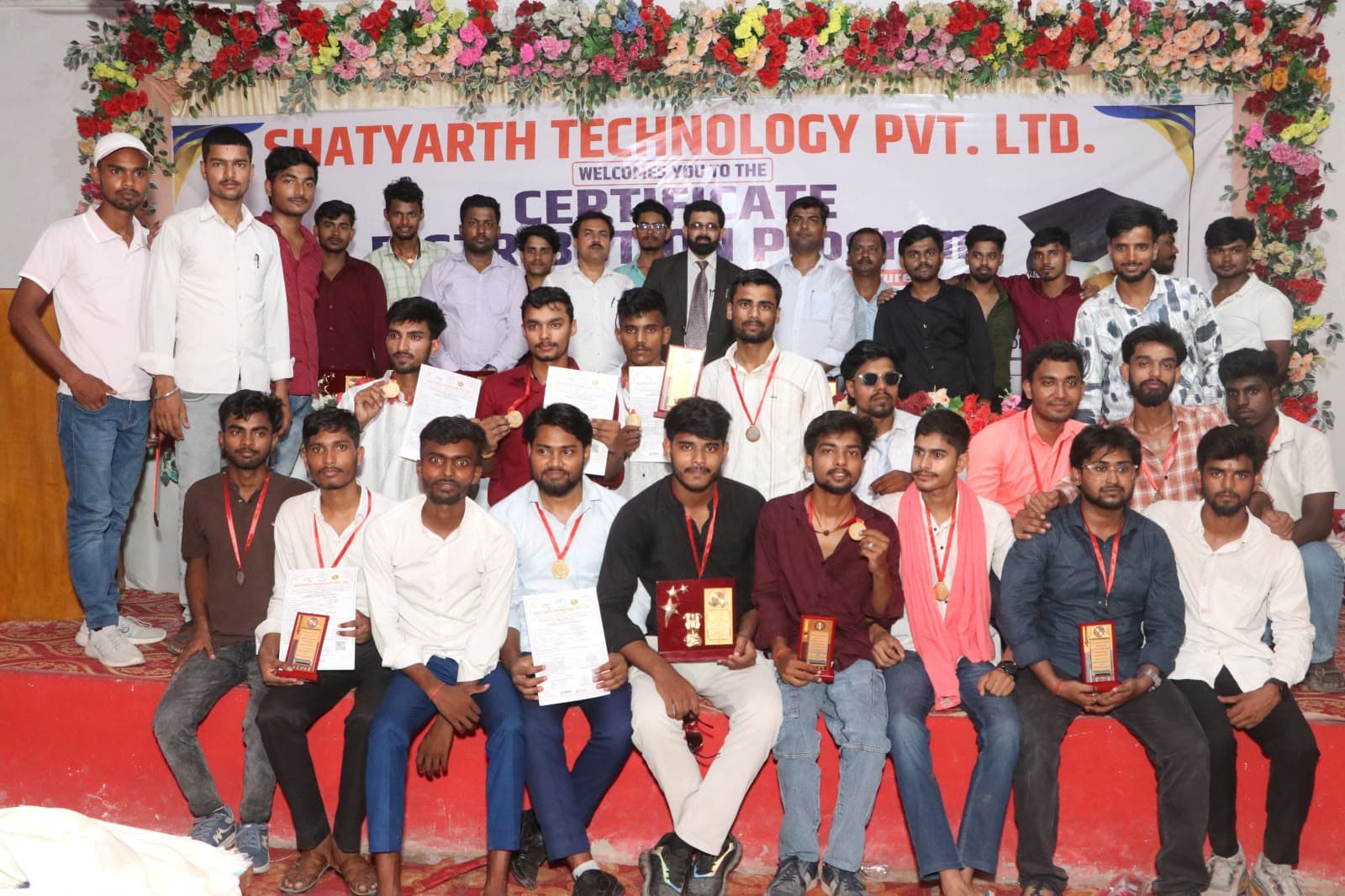 Male students with their certificates and medals at the Certificate Distribution Program