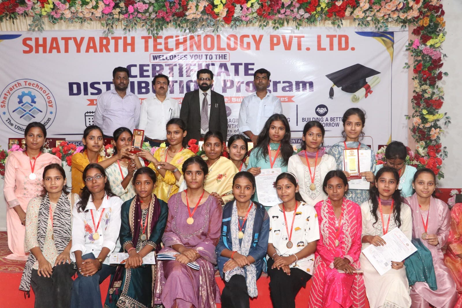 Female students with their certificates and medals at the Certificate Distribution Program